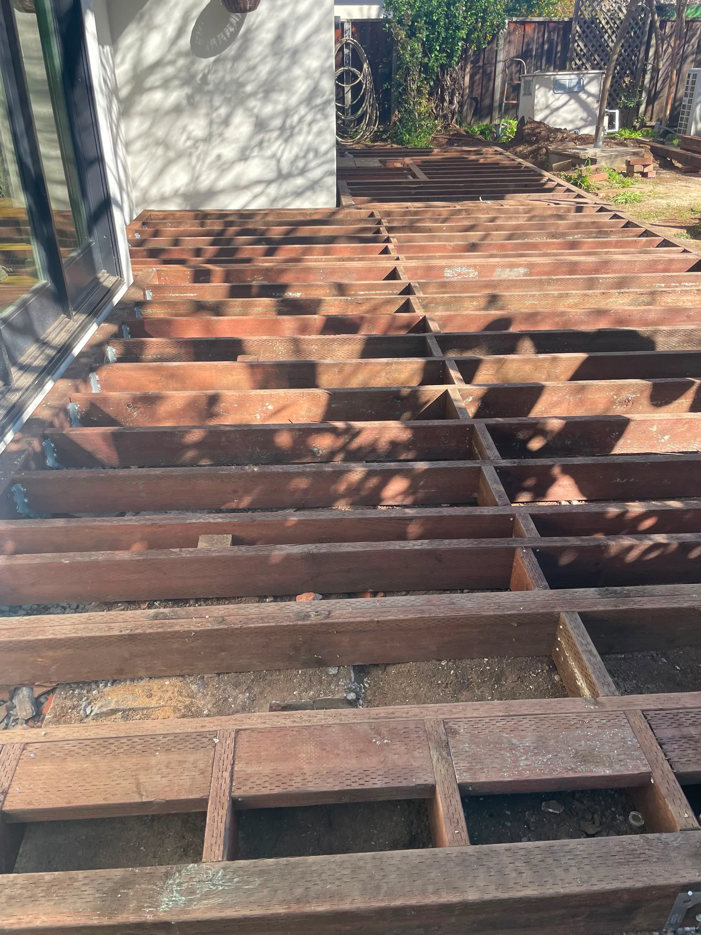 Deck joists exposed during a Double Y Framing deck repair