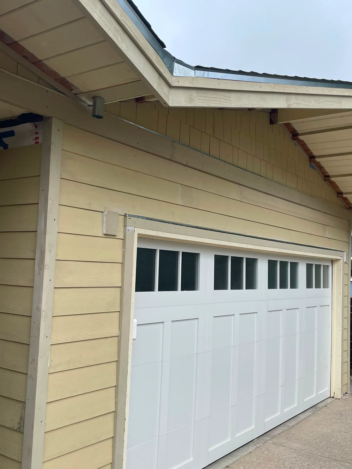 Finished exterior garage door and siding