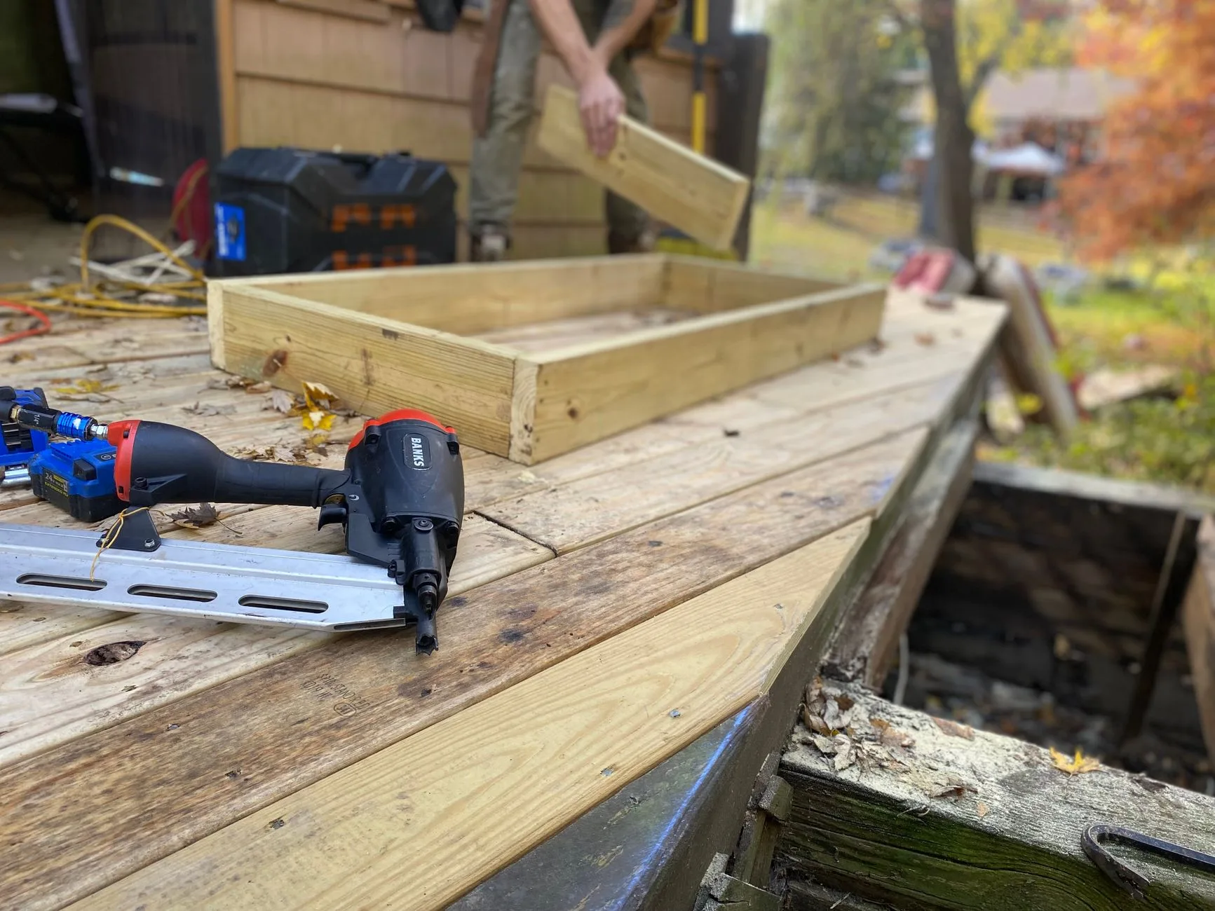 Carpenter framing a new wood deck